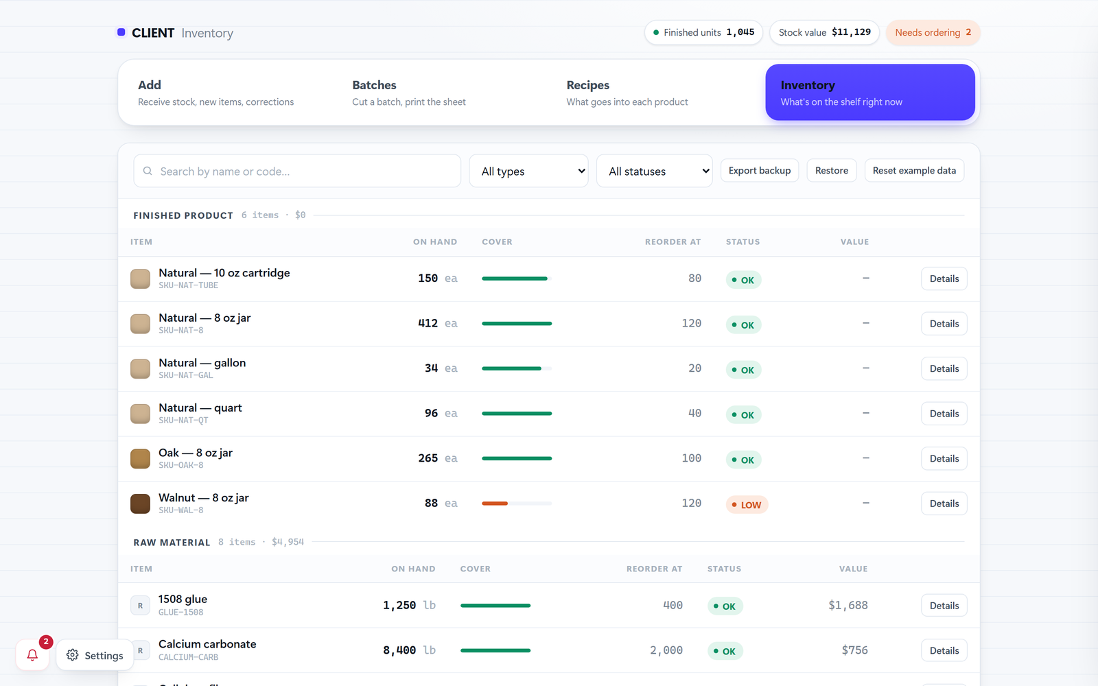 A stock-tracking screen: finished products and raw materials as rows with what's on hand, a cover bar, the reorder point, and an OK or LOW status. The company name is covered over.